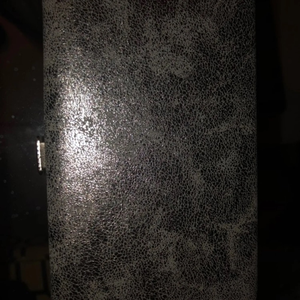 Silver colored wristlet and phone holder